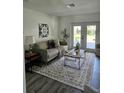 Cozy living room with comfortable seating, area rug, stylish decor, and french doors leading to the backyard at 13344 88Th Ave, Seminole, FL 33776