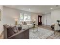 Bright living room with plush sofas, area rug, and a view of the front door at 13344 88Th Ave, Seminole, FL 33776