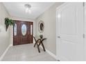 Inviting foyer features tile flooring, an elegant front door, and a decorative mirror at 14060 102Nd Ave, Largo, FL 33774