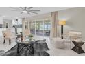 Bright living room with modern furnishings, stylish decor, and sliding doors to a screened porch at 14060 102Nd Ave, Largo, FL 33774