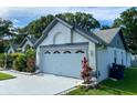 Attached two-car garage featuring a freshly painted exterior with decorative windows above the door at 15101 Bald Eagle St, Tampa, FL 33625