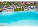 Expansive lagoon view showcasing the vibrant turquoise water, sandy beach, and recreational amenities at 16972 Oval Rum Dr, Wimauma, FL 33598