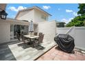 Outdoor patio with a dining table and chairs, offering a perfect space for entertaining with BBQ grill at 1712 Azalea Ct # B, Oldsmar, FL 34677