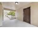 Hallway view showing elevator access with views of a walkway overlooking a landscaped view at 2192 Swedish Dr # 26, Clearwater, FL 33763