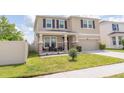 Charming two-story home with a manicured lawn, covered front porch, and a two-car garage at 3052 Living Coral Dr, Odessa, FL 33556