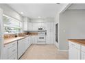 Bright kitchen featuring white cabinetry, stainless appliances, and ample counter space at 3901 17Th N Ave, St Petersburg, FL 33713