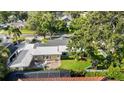 An aerial view shows a charming home with mature trees, a patio, and a well-maintained backyard at 4111 W Granada St, Tampa, FL 33629
