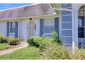 Lovely home featuring a neatly landscaped yard, a stone pathway, and charming blue shutters at 4207 Touchton Pl # 4207, New Port Richey, FL 34652