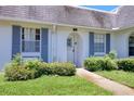 Attractive home with a well-manicured lawn, a stone pathway, and appealing blue shutters at 4207 Touchton Pl # 4207, New Port Richey, FL 34652