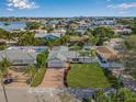 Stunning aerial view of waterfront community with palm trees and meticulously maintained landscaping and beautiful blue skies at 4495 Clearwater Harbor S Dr, Largo, FL 33770