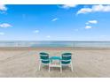 Picturesque beach scene with two Adirondack chairs offering a tranquil spot to enjoy the ocean view in this community at 5567 Sea Forest Dr # 323, New Port Richey, FL 34652
