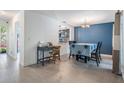 Open-concept dining room adjacent to the kitchen, featuring tile floors and a blue accent wall at 6 Harbor Cove St, Safety Harbor, FL 34695