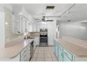 Kitchen featuring stainless steel appliances, light cabinets, and tiled floors at 675 69Th S Ave, St Petersburg, FL 33712
