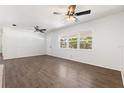 Bright living room featuring new flooring, large windows, and ceiling fans at 675 69Th S Ave, St Petersburg, FL 33712