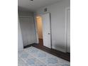 Bright bedroom featuring stylish flooring, a comfortable bed with blue patterned linens, and closet space at 702 Cypress Pl, Sun City Center, FL 33573