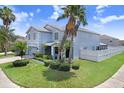 Exterior view of home with well maintained landscaping, backyard fence and lush green lawn under a bright blue sky at 7515 Dragon Fly Loop, Gibsonton, FL 33534