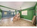 Spacious open-concept area featuring wood-look tile floors, neutral walls, and natural light at 8606 N 9Th St, Tampa, FL 33604