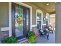 Inviting front porch with decorative wreath, seating, and colorful plants adds to the curb appeal at 11044 Spring Point Cir, Riverview, FL 33579