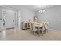 Dining room with neutral colors, decorative buffet, and view of the front door at 11295 Timber Grove Ln, Brooksville, FL 34613