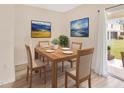 Light-filled dining room with wood table and chairs and sliding glass doors to the patio at 12710 Buffalo Run Drive, Gibsonton, FL 33534