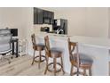 Bright kitchen featuring a breakfast bar with seating, sleek countertops and stainless steel sink at 12710 Buffalo Run Drive, Gibsonton, FL 33534