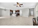 Open-concept living space with tile flooring connecting to the kitchen and entryway at 13324 Willow Bluestar Loop, Riverview, FL 33579