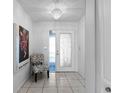 Bright entryway featuring decorative tile flooring and a stylish light fixture at 1617 Leland Dr, Sun City Center, FL 33573