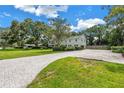 Beautiful home with manicured lawn, brick-paved driveway, lush landscaping and classic curb appeal at 1628 Long Bow Ln, Clearwater, FL 33764