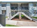 Exterior view of the condo featuring a private screened lanai accessible by stairs at 2049 Skimmer W Ct # 311, Clearwater, FL 33762