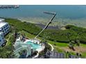 Aerial view of community pool and pier with waterfront access and dock at 2201 Bay Club Cir, Tampa, FL 33607