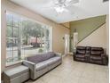 Bright and airy living room with large windows, tile flooring, and neutral paint, perfect for modern living at 243 Alexander Woods Dr, Plant City, FL 33563