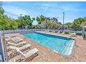 Sparkling community pool surrounded by lounge chairs and a well-maintained deck, offering a relaxing outdoor space at 243 Alexander Woods Dr, Plant City, FL 33563
