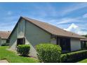 Exterior shot of the home showcasing the roofline and lush landscaping at 2588 Laurelwood Dr # 16A, Clearwater, FL 33763