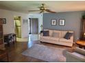 Cozy living room featuring a comfortable sofa, ceiling fan, and hardwood floors at 2588 Laurelwood Dr # 16A, Clearwater, FL 33763