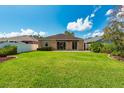 Spacious backyard featuring a lush green lawn and an expansive view of the property at 27652 Sky Lake Cir, Wesley Chapel, FL 33544