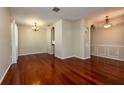 Open-concept living and dining area with hardwood floors and neutral wall colors at 27652 Sky Lake Cir, Wesley Chapel, FL 33544
