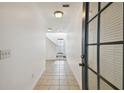 Inviting hallway with tile flooring, white walls, and a staircase leading to the upper level at 3111 W De Leon St # 9, Tampa, FL 33609