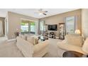 Bright living room featuring neutral colors, plush sofas, and sliding glass doors to the patio at 320 Roxbury Crossing Ct, Valrico, FL 33594