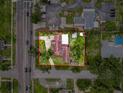An aerial view of a landscaped property featuring a charming home, mature trees, and a spacious driveway at 425 49Th N St, St Petersburg, FL 33710
