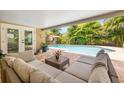 Inviting outdoor patio with comfortable seating, a view of the pool, and access to indoor spaces at 4915 Stolls Ave, Tampa, FL 33615