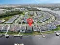 Aerial view of canal community featuring a blue two-story home on a canal with a private dock at 5307 Wishing Arch Dr, Apollo Beach, FL 33572