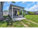 Single-story home with a covered carport and vibrant yellow front door surrounded by greenery at 5741 91St N Ave, Pinellas Park, FL 33782