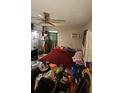 Bedroom with a red comforter on the bed, a ceiling fan, and an AC unit in the window at 714 Gray S St, Gulfport, FL 33707