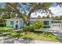 Charming single-story home features a welcoming front yard with mature landscaping at 745 Bruce Ave, Clearwater Beach, FL 33767