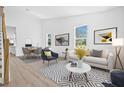 Bright living room featuring modern decor, wood floors, and ample natural light at 7617 Alvina St, Tampa, FL 33625