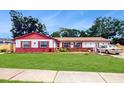 Charming single Gathering home with well-maintained lawn, eye-catching exterior and manicured landscape at 7710 Jackson Springs Rd, Tampa, FL 33615