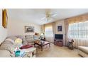 Traditional living room featuring neutral-toned sectional, plush carpeting, and abundant natural light at 7710 Jackson Springs Rd, Tampa, FL 33615