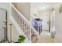 Bright entryway with staircase, tile flooring, and an impressive fish tank at 1012 Seminole Sky Dr, Ruskin, FL 33570