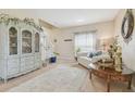 Cozy living room featuring a decorative hutch, staircase, and neutral decor at 1012 Seminole Sky Dr, Ruskin, FL 33570