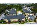 Aerial view of community featuring multiple buildings, a pool area, and lush landscaping at 12261 Sailwinds Dr # 203, Largo, FL 33773